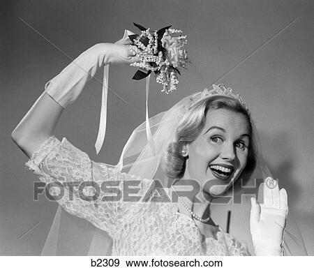 Stock Photo - 1950S Bride Throwing Bouquet And Waving Goodbye Smiling. Fotosearch