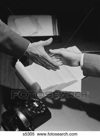 1950S Close-Up Two Male Hands About To Shake Over Desk With Papers And Telephone View Large Photo Image Stock Photography - 1950S Close-Up Two Male Hands About To Shake Over Desk With Papers And Telephone . Fotosearch