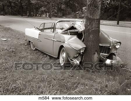 1950S Convertible Crashed Head-On Into A Tree Outdoor View Large Photo Image Picture - 1950S Convertible Crashed Head-On Into A Tree Outdoor. Fotosearch