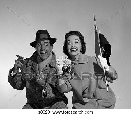 Stock Image - 1950S Couple Portrait In Coats Rooting For Home Team. Fotosearch