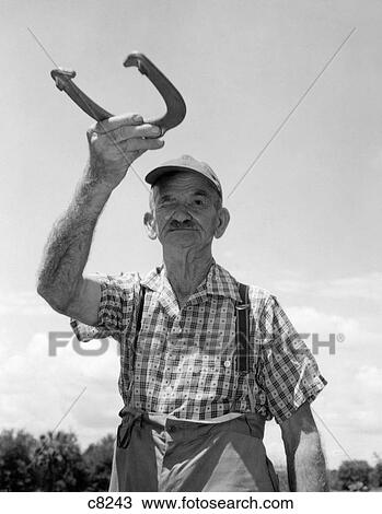 1950S Elderly Man Squinting One Eye Getting Ready To Pitch Horseshoe View Large Photo Image Stock Image - 1950S Elderly Man Squinting One Eye Getting Ready To Pitch Horseshoe. Fotosearch