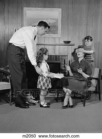 1950S Family Living Room Woman Mother Getting Surprise Gift From Children Daughter Son Husband View Large Photo Image Stock Image - 1950S Family Living Room Woman Mother Getting Surprise Gift From Children Daughter Son Husband. Fotosearch