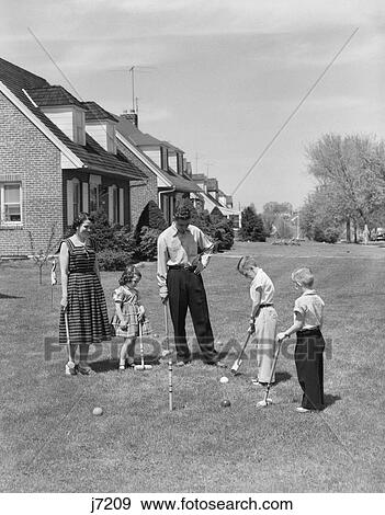 1950S Family Mother Father 3 Children Playing Croquet Front Lawn Suburban Home View Large Photo Image Stock Photo - 1950S Family Mother Father 3 Children Playing Croquet Front Lawn Suburban Home. Fotosearch