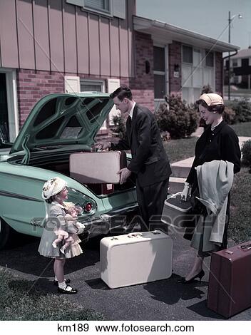 1950S Family Mother Father Daughter In Front Of Suburban House Packing Luggage In Car For Vacation View Large Photo Image Stock Photo - 1950S Family Mother Father Daughter In Front Of Suburban House Packing Luggage In Car For Vacation . Fotosearch