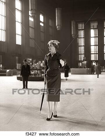 Stock Photo - 1950S Fashionable High Class Woman Alone Train Station Umbrella Waiting Lonely. Fotosearch