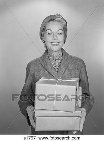 1950S Fashionably Dressed Woman Holding Packages Wrapped In Brown Paper And String View Large Photo Image Stock Photo - 1950S Fashionably Dressed Woman Holding Packages Wrapped In Brown Paper And String. Fotosearch
