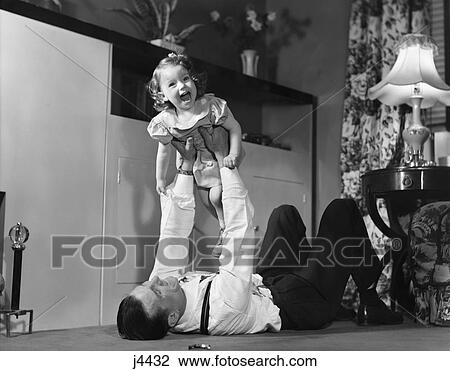 1950S Father Lying Floor Holding Daughter Girl Up In The Air View Large Photo Image Stock Image - 1950S Father Lying Floor Holding Daughter Girl Up In The Air . Fotosearch