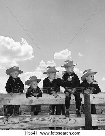 1950S Five Boys Brothers Dressed As Cowboys Sitting Together On Corral Fence View Large Photo Image Stock Image - 1950S Five Boys Brothers Dressed As Cowboys Sitting Together On Corral Fence . Fotosearch