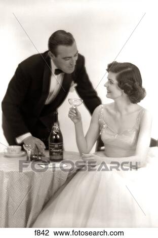 1950S Formal Dress Couple Man In Tuxedo Woman Wearing Gown Holding Champagne Glass View Large Photo Image Stock Image - 1950S Formal Dress Couple Man In Tuxedo Woman Wearing Gown Holding Champagne Glass. Fotosearch