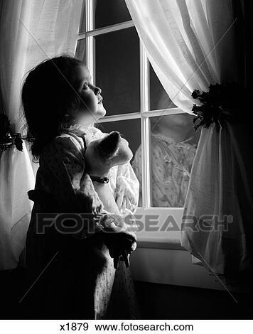 1950S Girl In Flannel Nightgown Holding Stuffed Animal Looking Out Window At Night With Curtains Held Back By Holly View Large Photo Image Stock Photo - 1950S Girl In Flannel Nightgown Holding Stuffed Animal Looking Out Window At Night With Curtains Held Back By Holly. Fotosearch