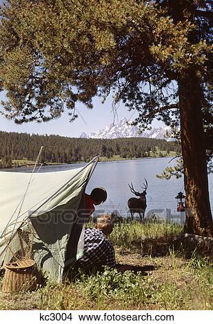 1950S Grand Teton National Park Wyoming Two Children In Tent Looking At Deer By Lake View Large Photo Image Picture - 1950S Grand Teton National Park Wyoming Two Children In Tent Looking At Deer By Lake. Fotosearch