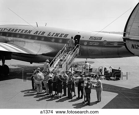 1950S Group Of Passengers Boarding Commercial Propeller Airplane Washington Dc View Large Photo Image Picture - 1950S Group Of Passengers Boarding Commercial Propeller Airplane Washington Dc. Fotosearch