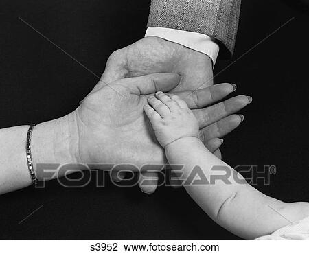 Stock Image - 1950S Hands Of Family Man Woman Child Mother Father Baby. Fotosearch