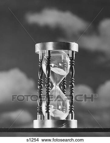 1950S Hourglass Against Background Of Clouds View Large Photo Image Picture - 1950S Hourglass Against Background Of Clouds. Fotosearch