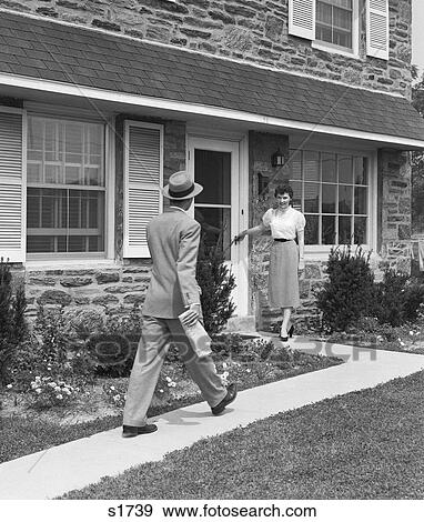 1950S Man Coming Home Down Sidewalk Woman Waiting At Door View Large Photo Image Stock Photo - 1950S Man Coming Home Down Sidewalk Woman Waiting At Door . Fotosearch