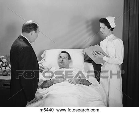 1950S Man Doctor Woman Nurse Talking With Male Patient Lying In Hospital Bed View Large Photo Image Stock Image - 1950S Man Doctor Woman Nurse Talking With Male Patient Lying In Hospital Bed. Fotosearch