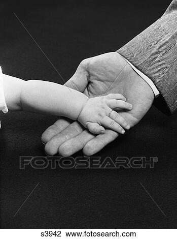 1950S Man Hand Holding Supporting Baby Hand View Large Photo Image Stock Image - 1950S Man Hand Holding Supporting Baby Hand. Fotosearch