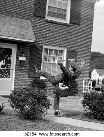 1950S Man Mailman Tripping Falling In Front Of A Suburban Brick House Accident View Large Photo Image Picture - 1950S Man Mailman Tripping Falling In Front Of A Suburban Brick House Accident. Fotosearch
