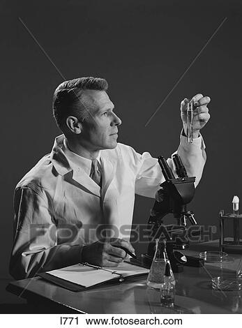 1950S Man Scientist Holding Test Tube Making Notes By Microscope View Large Photo Image Stock Image - 1950S Man Scientist Holding Test Tube Making Notes By Microscope . Fotosearch