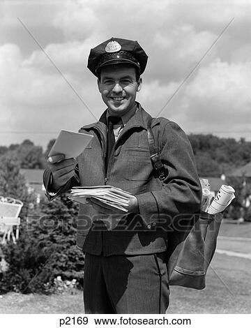Stock Photo - 1950S Man Smiling Postman Holding Out Letter. Fotosearch