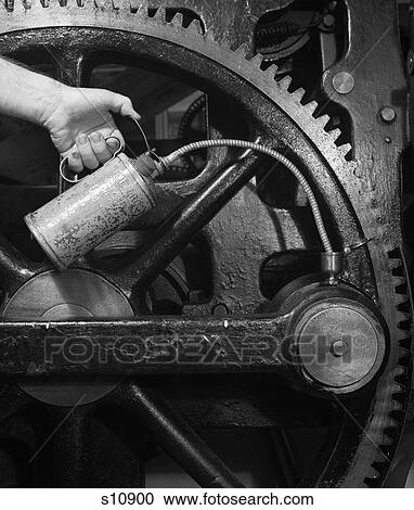 1950S Mans Hand Oil Can Oiling Gears Industrial Machine Printing Press View Large Photo Image Stock Image - 1950S Mans Hand Oil Can Oiling Gears Industrial Machine Printing Press. Fotosearch