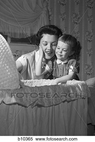 1950S Mother & Daughter Admiring Baby In Bassinet View Large Photo Image Stock Photography - 1950S Mother & Daughter Admiring Baby In Bassinet. Fotosearch