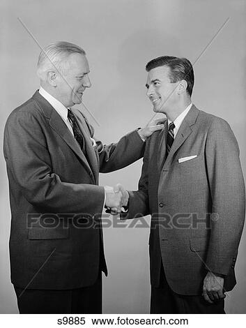 1950S Older And Younger Business Men Shaking Hands View Large Photo Image Stock Photography - 1950S Older And Younger Business Men Shaking Hands. Fotosearch
