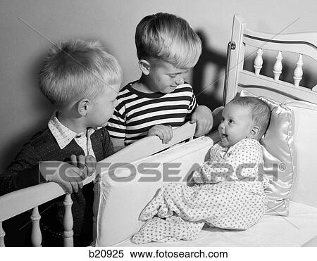 1950S Pair Of Boys Looking Down At Baby Sister Lying In Crib View Large Photo Image Stock Photography - 1950S Pair Of Boys Looking Down At Baby Sister Lying In Crib. Fotosearch