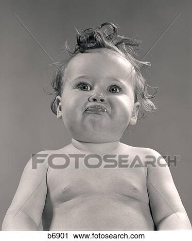 1950S Portrait Baby With Messy Hair & Pursed Lips View Large Photo Image Stock Image - 1950S Portrait Baby With Messy Hair & Pursed Lips. Fotosearch