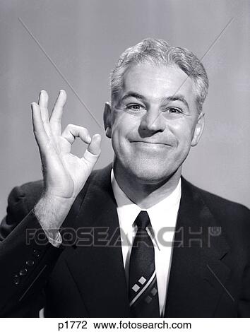 1950S Portrait Of Happy Smiling Man Businessman Salesman Making An Ok Hand Sign View Large Photo Image Stock Image - 1950S Portrait Of Happy Smiling Man Businessman Salesman Making An Ok Hand Sign. Fotosearch