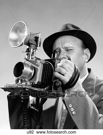 1950S Portrait Of Photographer Man In Suit And Fedora Hat Squinting Eye To Look Through Viewfinder Of Press Camera View Large Photo Image Stock Image - 1950S Portrait Of Photographer Man In Suit And Fedora Hat Squinting Eye To Look Through Viewfinder Of Press Camera. Fotosearch