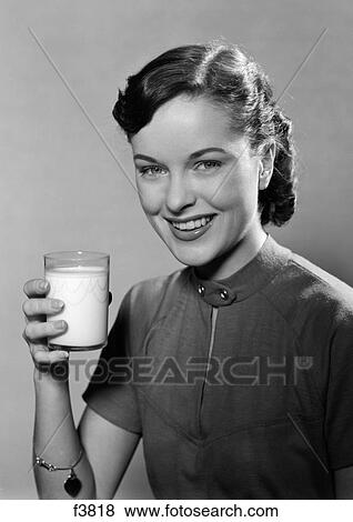 Stock Photo - 1950S Portrait Smiling Woman Holding A Glass Of Milk Studio. Fotosearch