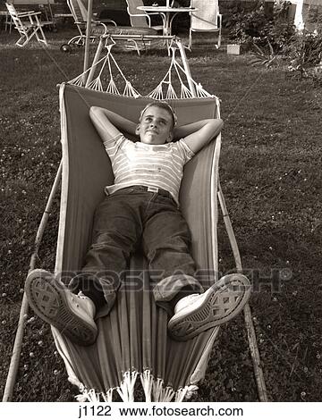 1950S Relaxed Smiling Boy Lying In Suburban Backyard Hammock View Large Photo Image Stock Image - 1950S Relaxed Smiling Boy Lying In Suburban Backyard Hammock. Fotosearch