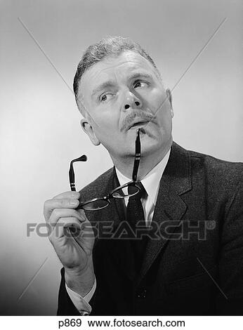 1950S Serious Thinking Thoughtful Older Man Holding Eyeglasses To Chin View Large Photo Image Stock Photo - 1950S Serious Thinking Thoughtful Older Man Holding Eyeglasses To Chin. Fotosearch