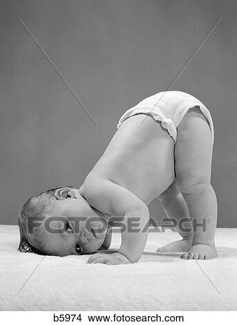 Picture - 1950S Side View Of Portrait Baby In Diaper With Cheek To Floor And Bottom In Air. Fotosearch