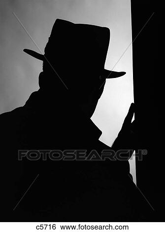 1950S Silhouette Of Man Intruder In Hat And Coat With One Hand On A Door Frame View Large Photo Image Stock Photograph - 1950S Silhouette Of Man Intruder In Hat And Coat With One Hand On A Door Frame. Fotosearch