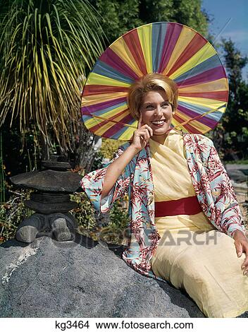Picture - 1950S Smiling Blond Woman Wearing Japanese Style Clothing And Funny Rainbow Colors Sun Hat. Fotosearch
