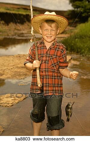 1950S Smiling Boy Straw Hat Holding Fishing Pole Wearing Plaid Shirt Blue Jeans View Large Photo Image Stock Image - 1950S Smiling Boy Straw Hat Holding Fishing Pole Wearing Plaid Shirt Blue Jeans . Fotosearch