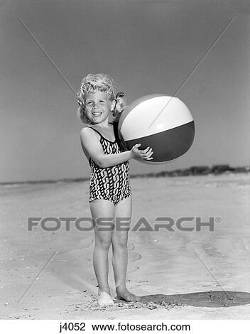 1950S Smiling Girl Standing On Beach Holding Beach Ball Looking At Camera View Large Photo Image Stock Image - 1950S Smiling Girl Standing On Beach Holding Beach Ball Looking At Camera. Fotosearch