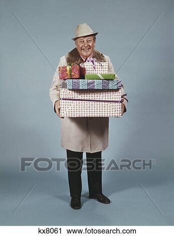 1950S Smiling Man Hat Coat Carrying Wrapped Christmas Presents View Large Photo Image Stock Image - 1950S Smiling Man Hat Coat Carrying Wrapped Christmas Presents. Fotosearch