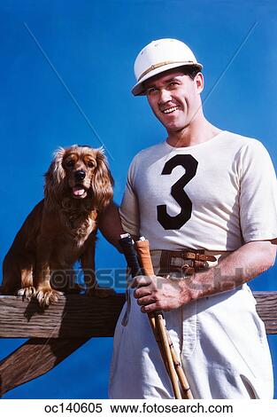 1950S Smiling Man Polo Player Posing With Cocker Spaniel Dog Looking At Camera View Large Photo Image Stock Photography - 1950S Smiling Man Polo Player Posing With Cocker Spaniel Dog Looking At Camera. Fotosearch