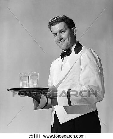 1950S Smiling Man Waiter Bartender In Bow Tie And White Jacket With Black Trim Chesterfield Collar Holding Serving Tray Looking At Camera View Large Photo Image Stock Image - 1950S Smiling Man Waiter Bartender In Bow Tie And White Jacket With Black Trim Chesterfield Collar Holding Serving Tray Looking At Camera. Fotosearch