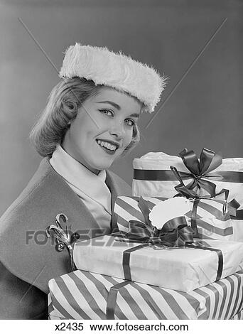 1950S Smiling Woman In Fur Hat Holding Wrapped Christmas Presents View Large Photo Image Stock Photography - 1950S Smiling Woman In Fur Hat Holding Wrapped Christmas Presents. Fotosearch