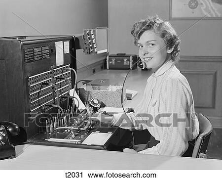 Stock Image - 1950S Smiling Woman Office Telephone Switchboard Operator . Fotosearch
