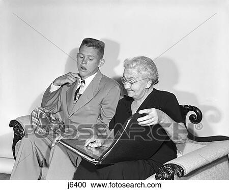 1950S Teen Boy Crew Cut Suit Tie Candy Box Valentine Sit Next To Old Woman Look Photo Album First Date Embarrassment View Large Photo Image Stock Image - 1950S Teen Boy Crew Cut Suit Tie Candy Box Valentine Sit Next To Old Woman Look Photo Album First Date Embarrassment. Fotosearch