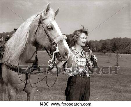 1950S Teenage Girl Western Wear Holding Horse Halter Drinking Carbonated Beverage From Bottle View Large Photo Image Stock Image - 1950S Teenage Girl Western Wear Holding Horse Halter Drinking Carbonated Beverage From Bottle. Fotosearch