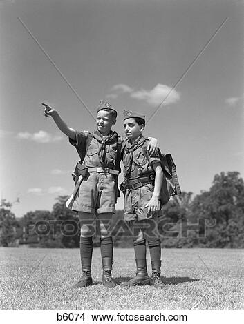 1950S Two Boy Scouts One Pointing Wearing Hiking Gear Uniforms View Large Photo Image Picture - 1950S Two Boy Scouts One Pointing Wearing Hiking Gear Uniforms. Fotosearch