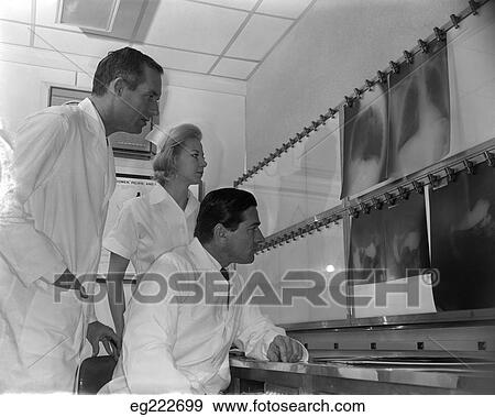 1950S Two Doctors And Nurse Examining X-Rays View Large Photo Image Stock Photo - 1950S Two Doctors And Nurse Examining X-Rays. Fotosearch