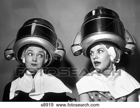 1950S Two Women Sitting Together Gossiping Under Hairdresser Hair Dryer View Large Photo Image Stock Photo - 1950S Two Women Sitting Together Gossiping Under Hairdresser Hair Dryer. Fotosearch