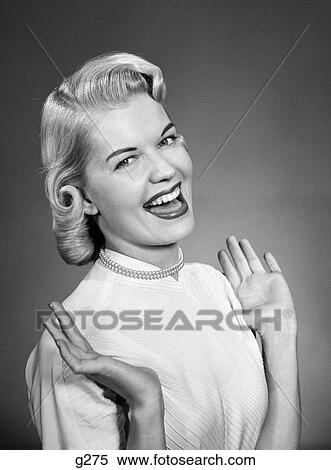 1950S Woman Wearing Pearls Smiling With Hands Up Thumbs Tucked Under Arm View Large Photo Image Stock Photography - 1950S Woman Wearing Pearls Smiling With Hands Up Thumbs Tucked Under Arm. Fotosearch